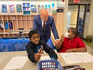 Dr. Vitti talks to male students 